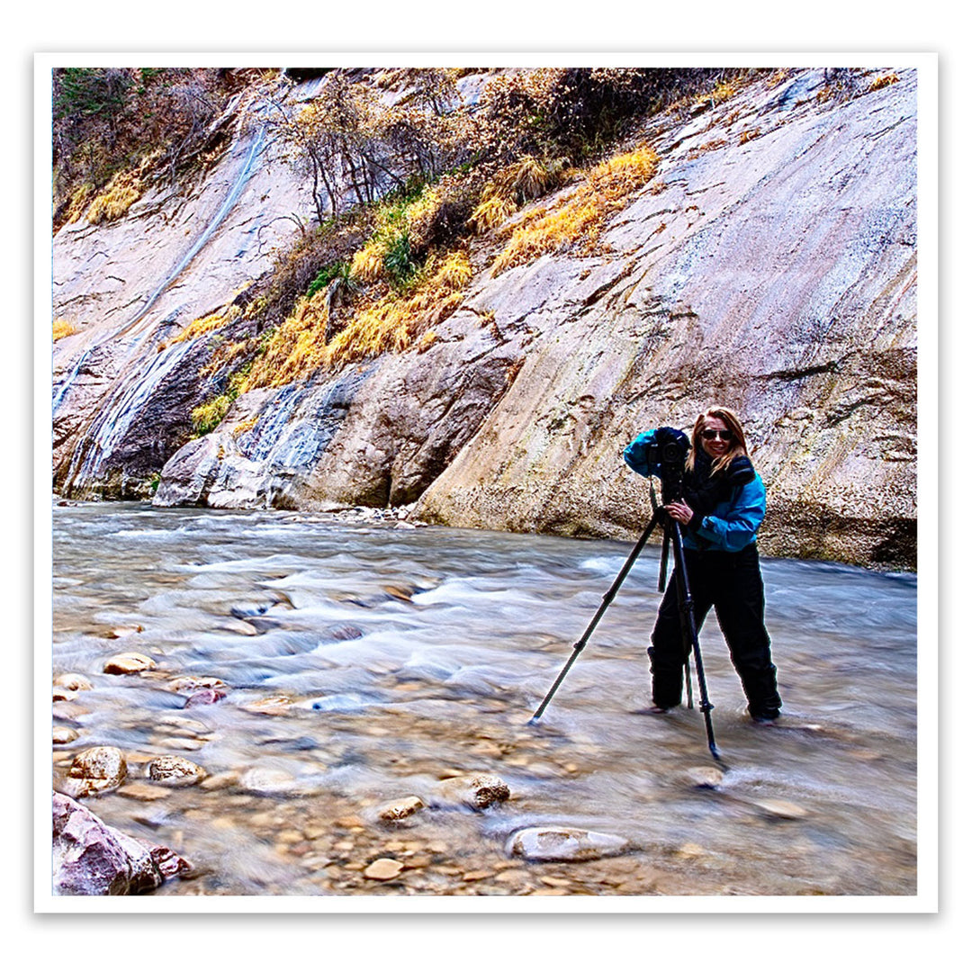 Susan Vizvary photographing while in a river bed